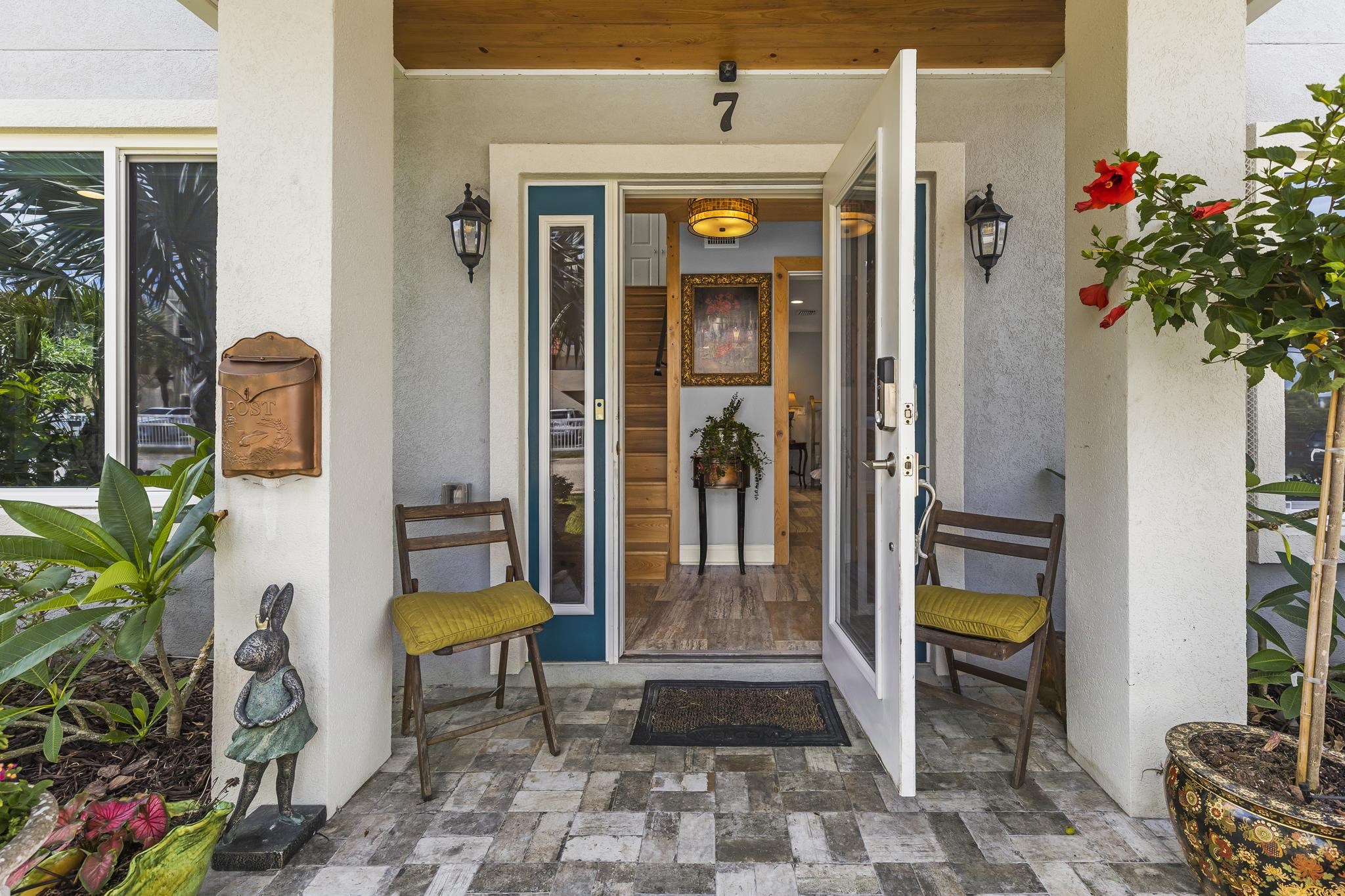 7 16th Street St. Augustine, FL 32080 - Photo 3 of 61 a view of a porch with a potted plant and floor to ceiling window