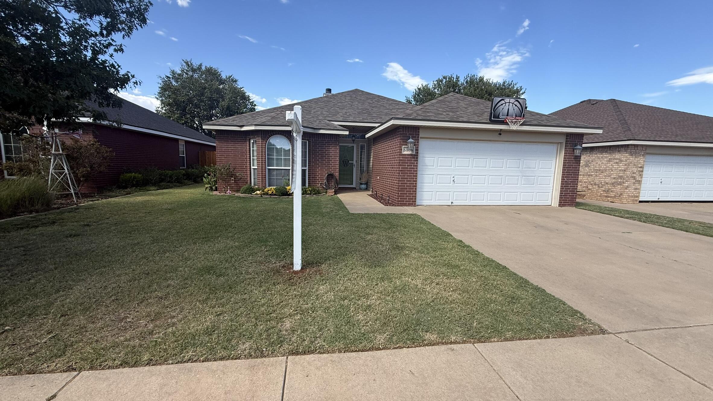 6808 84th Street Lubbock, TX 79424 - Photo 1 of 11 front view of a house with a yard