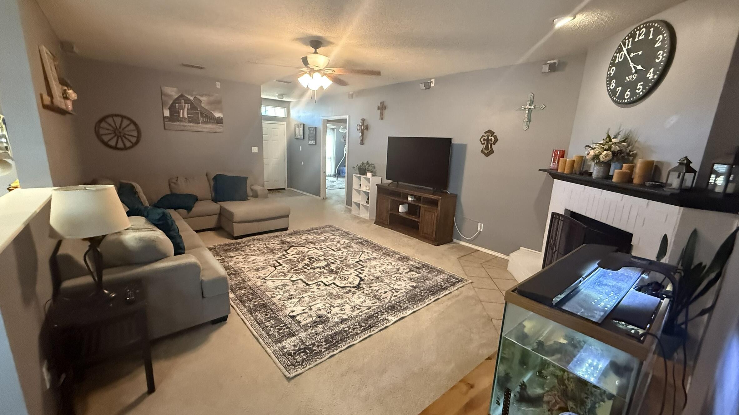 6808 84th Street Lubbock, TX 79424 - Photo 2 of 11 a living room with furniture and a flat screen tv