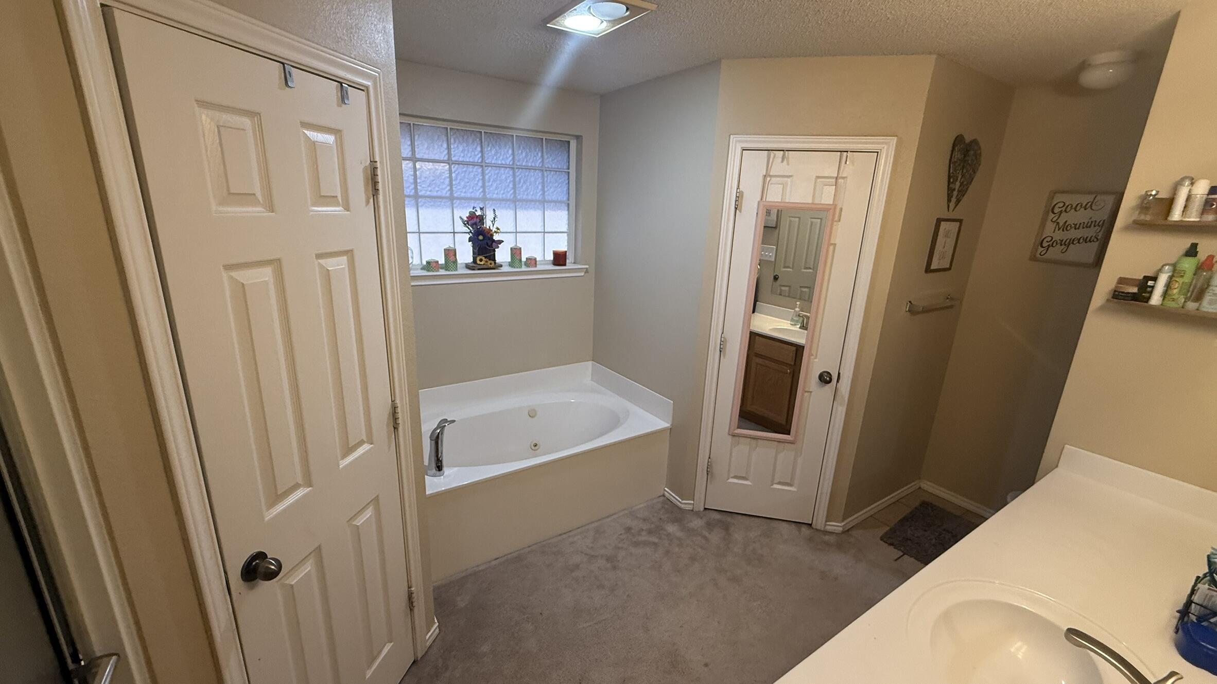 6808 84th Street Lubbock, TX 79424 - Photo 6 of 11 a bathroom with a tub and a sink