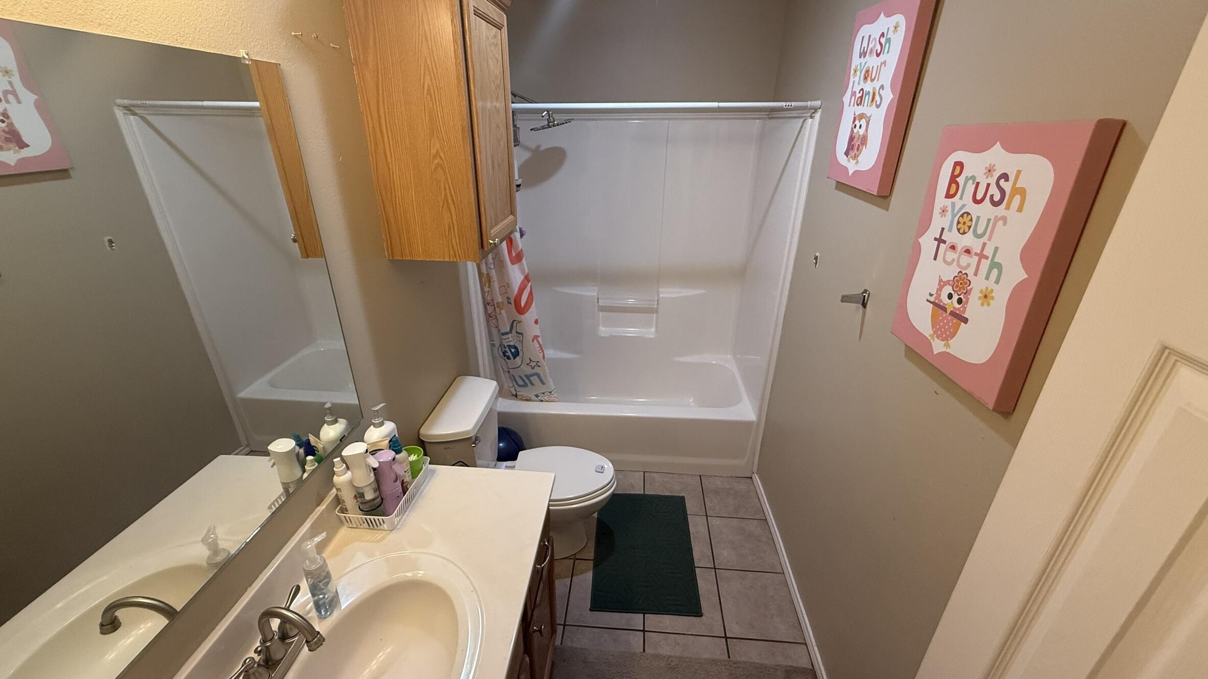 6808 84th Street Lubbock, TX 79424 - Photo 10 of 11 a bathroom with a sink and a mirror