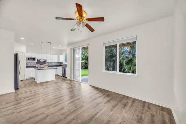 a view of kitchen with refrigerator and window