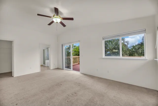 a view of a livingroom with a ceiling fan and window