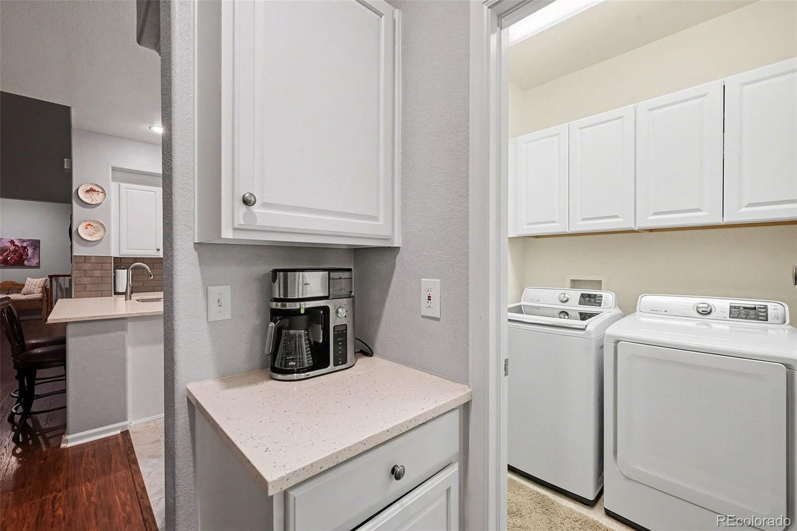 10546 Graymont Lane, Unit D Highlands Ranch, CO 80126 - Photo 12 of 21 a kitchen with white cabinets and white appliances