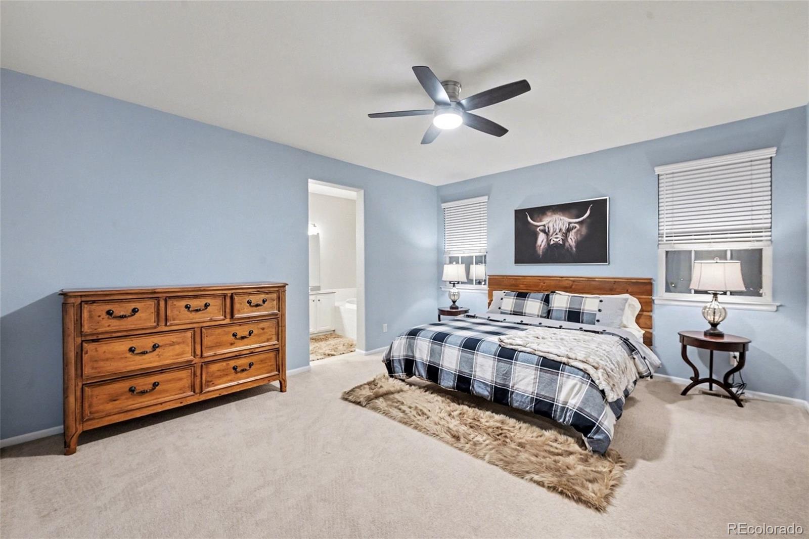 10546 Graymont Lane, Unit D Highlands Ranch, CO 80126 - Photo 14 of 21 a bedroom with a bed and a chandelier