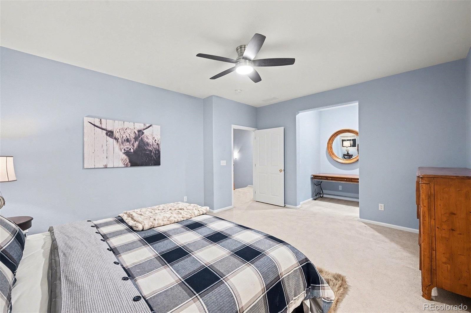 10546 Graymont Lane, Unit D Highlands Ranch, CO 80126 - Photo 15 of 21 a bedroom with a bed and a chandelier