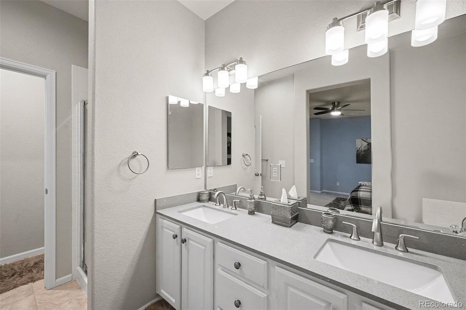 10546 Graymont Lane, Unit D Highlands Ranch, CO 80126 - Photo 16 of 21 a bathroom with a sink vanity and a mirror