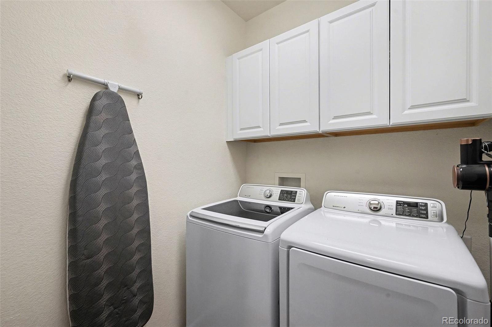 10546 Graymont Lane, Unit D Highlands Ranch, CO 80126 - Photo 20 of 21 a view of storage and utility room with washer and dryer