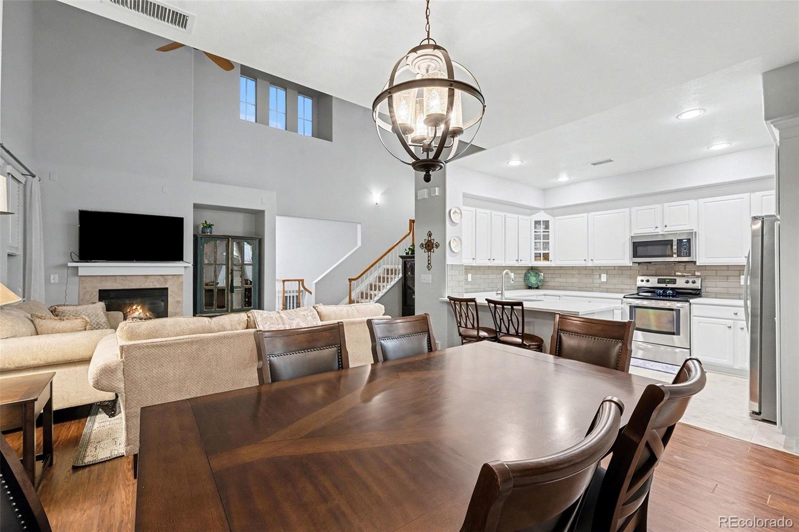 10546 Graymont Lane, Unit D Highlands Ranch, CO 80126 - Photo 7 of 21 a living room with fireplace furniture and a flat screen tv