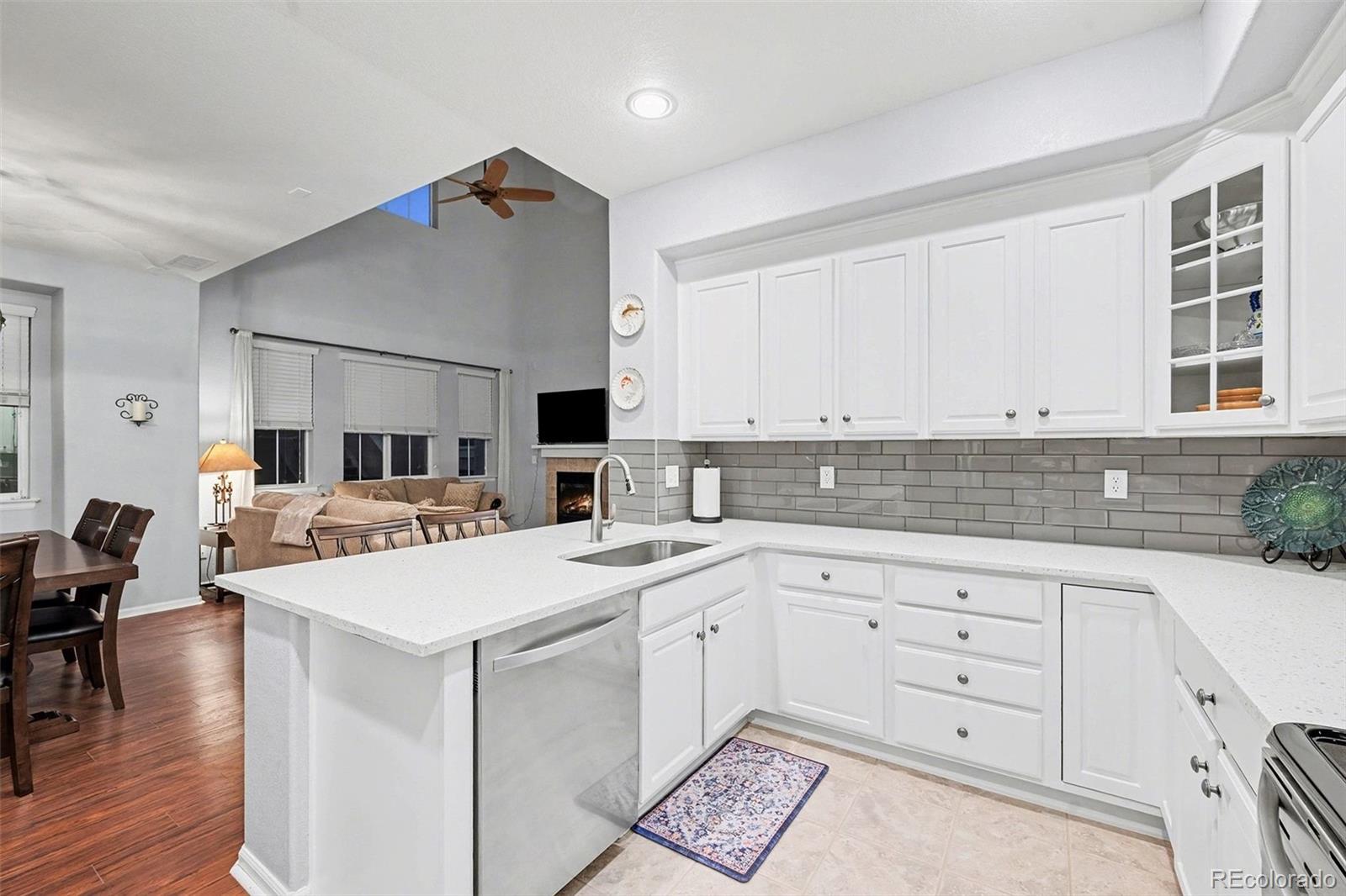 10546 Graymont Lane, Unit D Highlands Ranch, CO 80126 - Photo 10 of 21 a kitchen with a stove a sink and a refrigerator