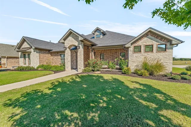 a view of house with yard and green space