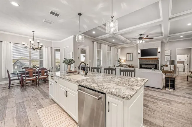 a kitchen with stainless steel appliances granite countertop a stove and a wooden floors