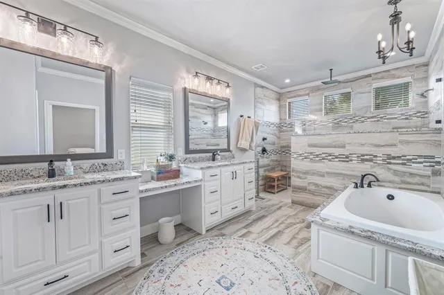 a spacious bathroom with a granite countertop sink mirror and bathtub