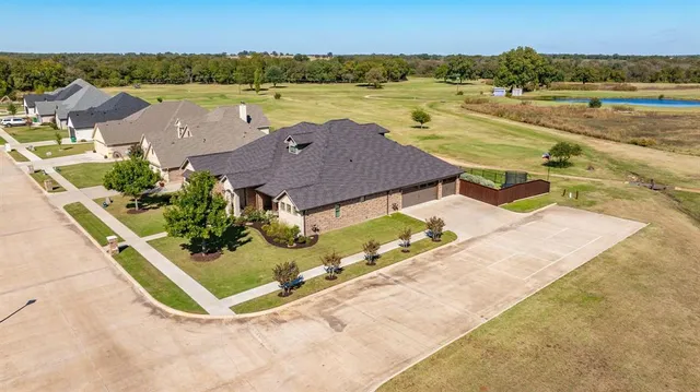 an aerial view of residential houses with outdoor space and river