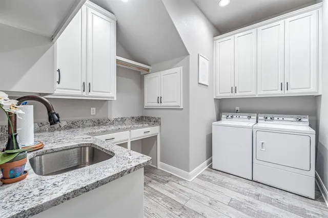 a view of a kitchen sink and dishwasher with wooden floor