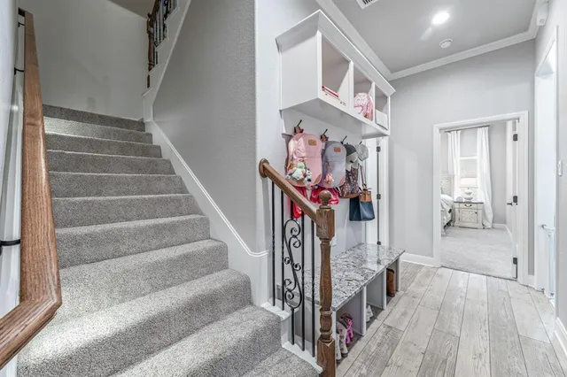 a view of an entryway with wooden floor and a chandelier