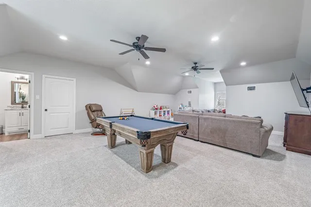 a living room with furniture and a ceiling fan