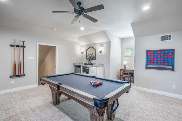 a room with pool table and wall paintings