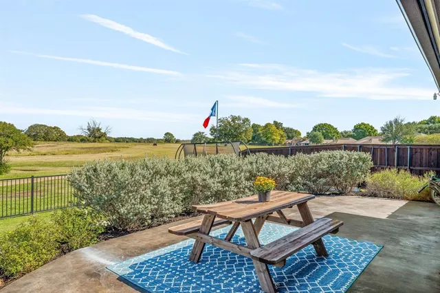 a view of a lake from balcony with outdoor seating