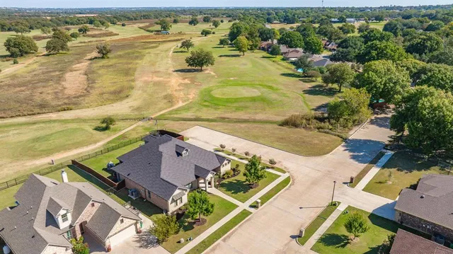 an aerial view of residential houses with outdoor space