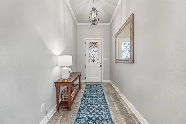 a bedroom with a bed and a lamp on a dresser