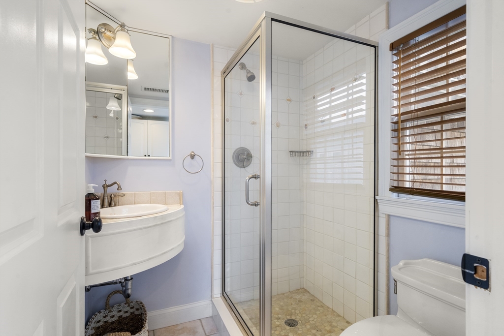 24 Cross Street Harwich, MA 02646 - Photo 12 of 34 a bathroom with a sink toilet and shower