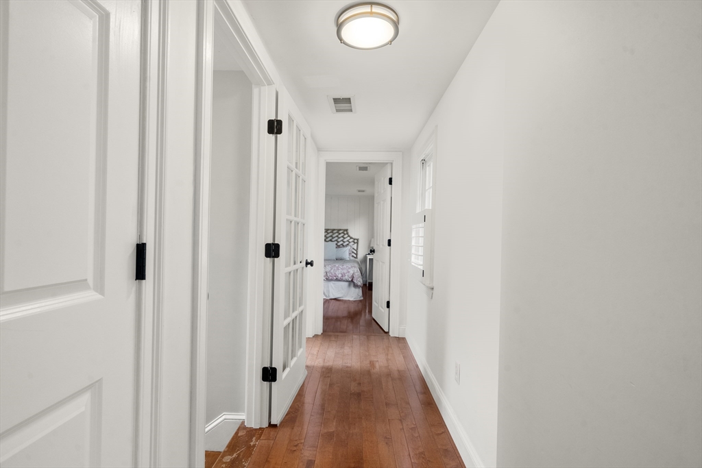 24 Cross Street Harwich, MA 02646 - Photo 13 of 34 a view of a hallway with wooden floor and a bathroom