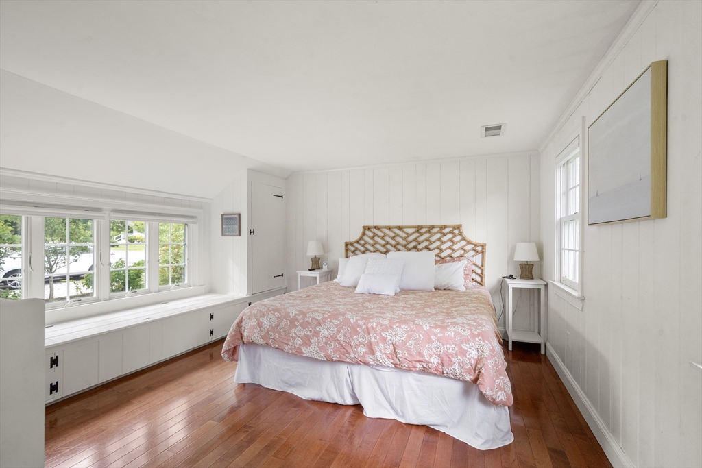 24 Cross Street Harwich, MA 02646 - Photo 16 of 34 a bedroom with a large bed and a large window