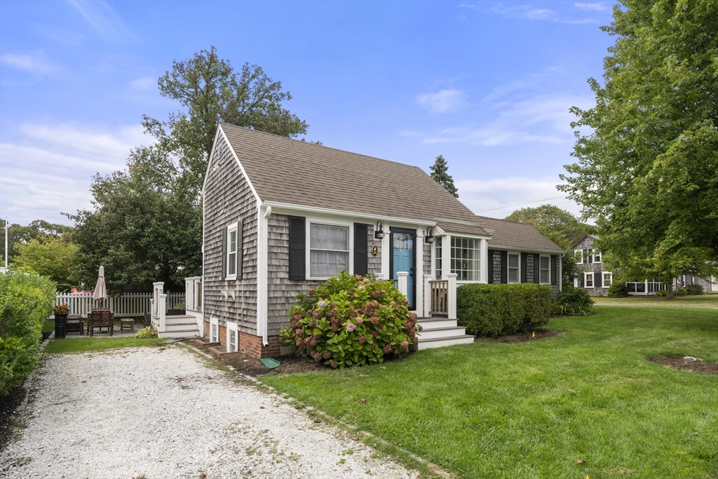 24 Cross Street Harwich, MA 02646 - Photo 2 of 34 a front view of a house with a garden