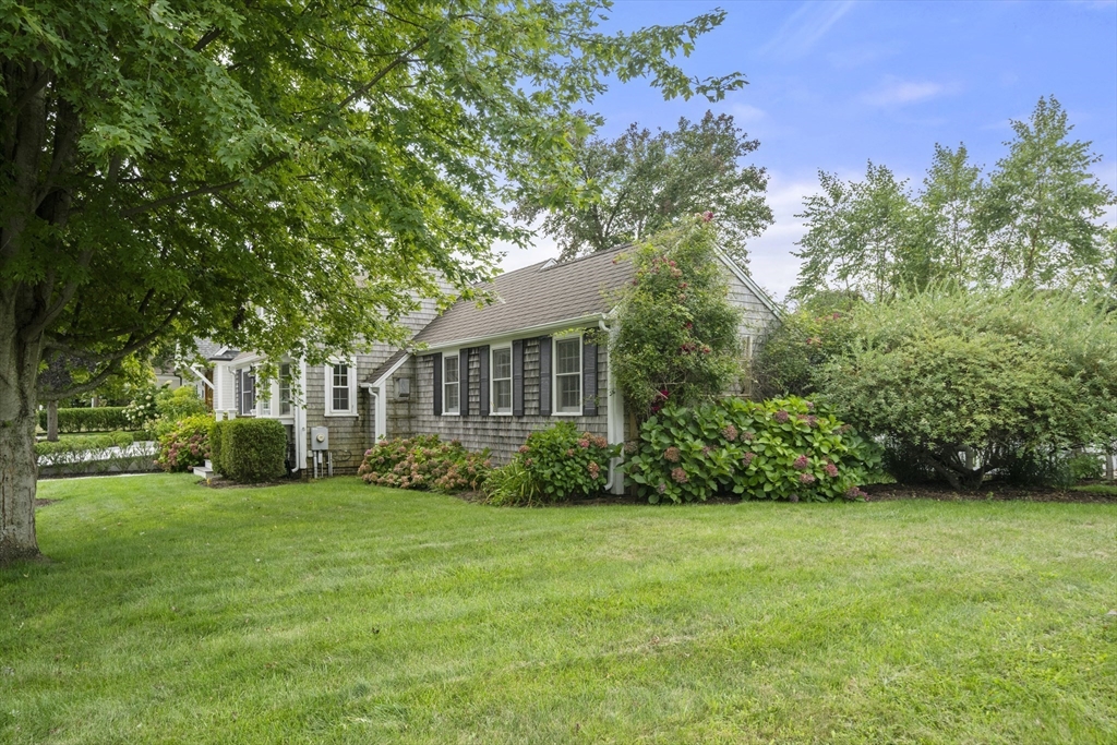 24 Cross Street Harwich, MA 02646 - Photo 26 of 34 a view of a yard in front of a house