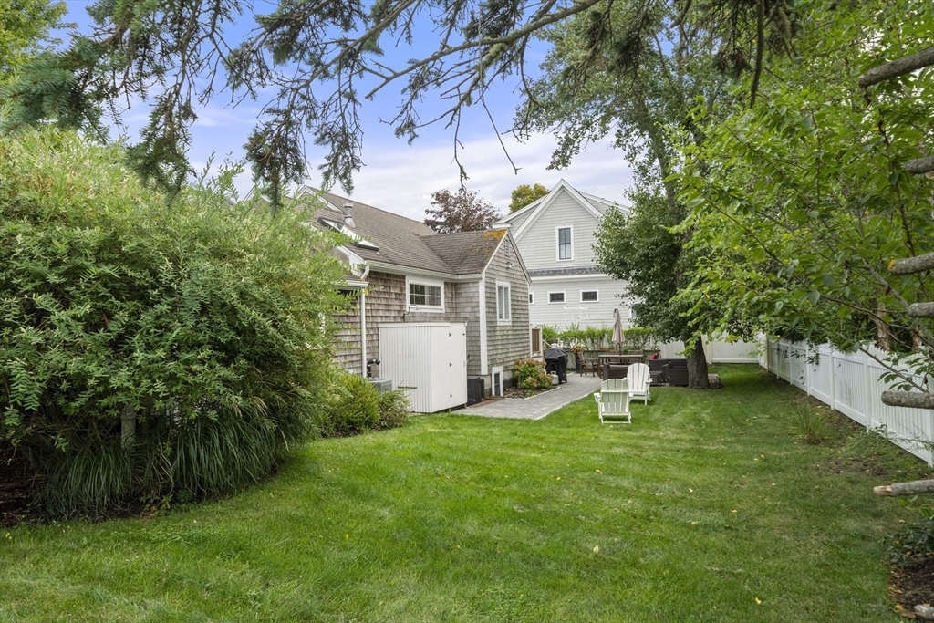 24 Cross Street Harwich, MA 02646 - Photo 27 of 34 a view of a house with a yard porch and sitting area