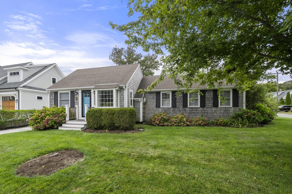 24 Cross Street Harwich, MA 02646 - Photo 3 of 34 a front view of a house with a yard