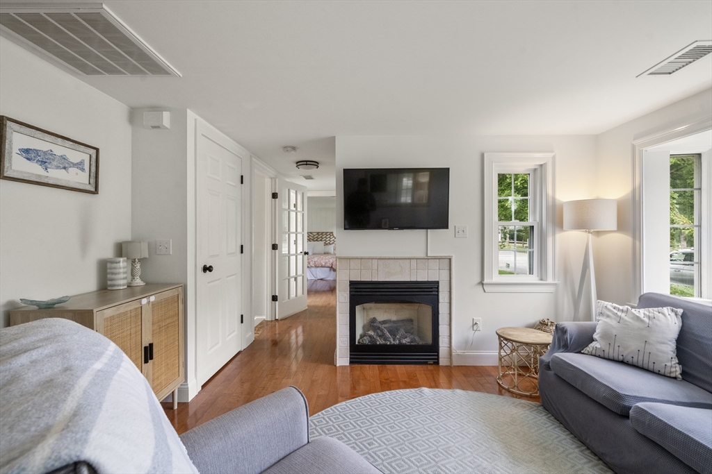 24 Cross Street Harwich, MA 02646 - Photo 5 of 34 a living room with furniture and a fireplace