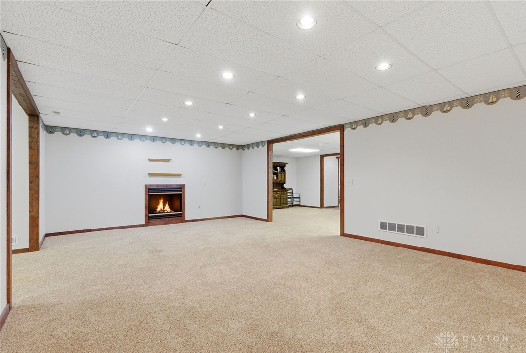 1540 Jasper Road Xenia, OH 45385 - Photo 49 of 91 This expansive basement offers comfort with a cozy fireplace and warm carpet flooring.