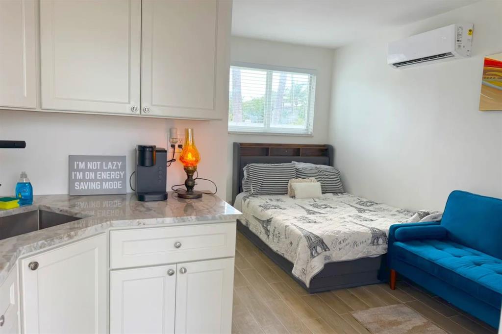 a bedroom with bed cabinet and window