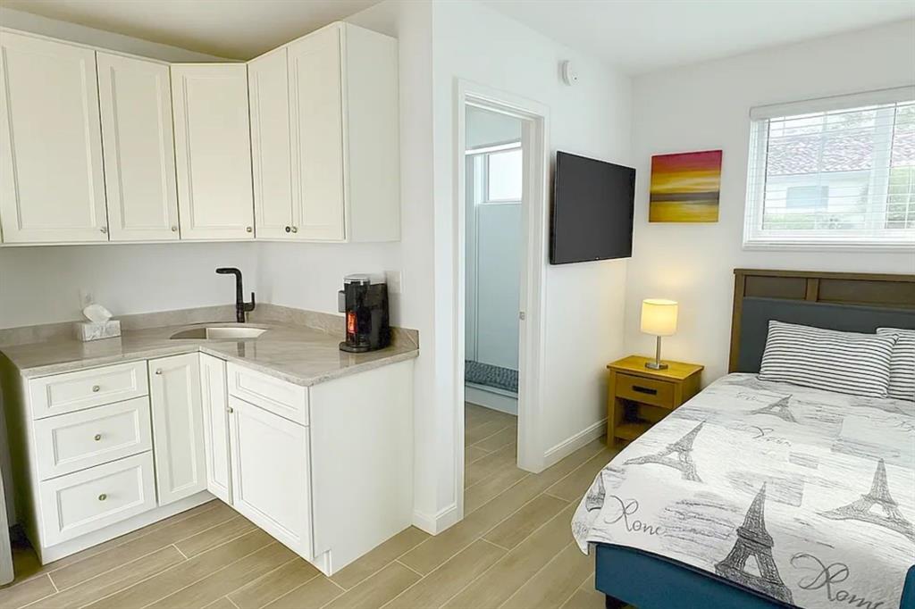 2250 Southeast 5th Street, Unit 6 Pompano Beach, FL 33062 - Photo 2 of 11 a bedroom with a bed and a tv