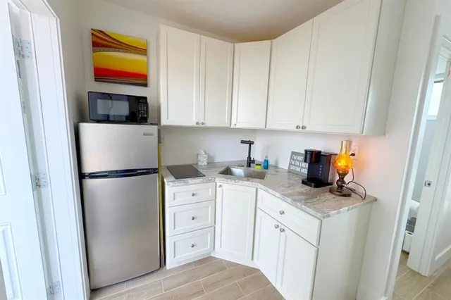 a kitchen with stainless steel appliances a refrigerator sink and cabinets