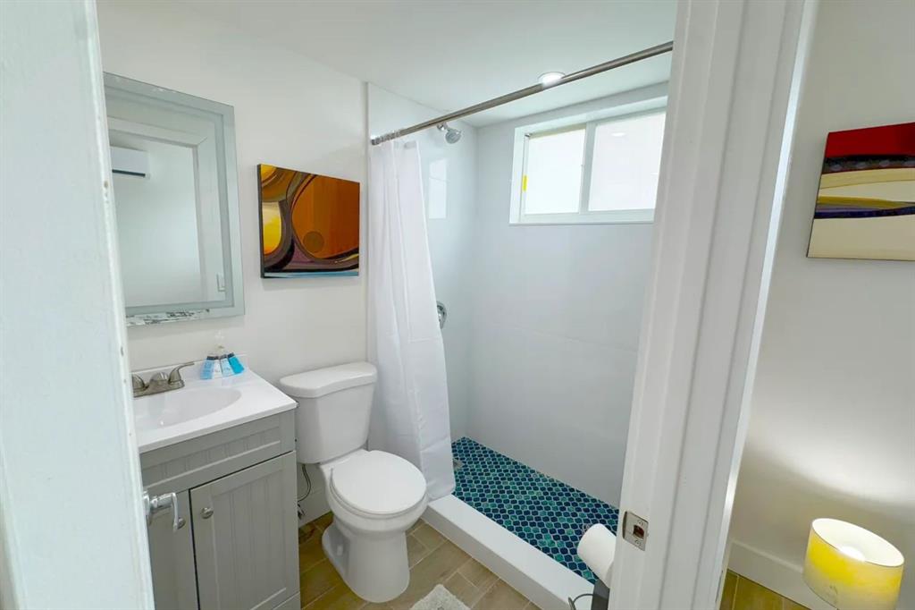 2250 Southeast 5th Street, Unit 6 Pompano Beach, FL 33062 - Photo 4 of 11 a bathroom with a toilet sink and mirror
