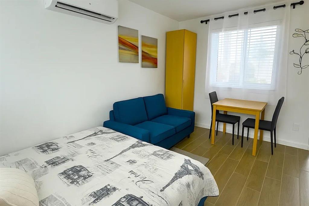 2250 Southeast 5th Street, Unit 6 Pompano Beach, FL 33062 - Photo 5 of 11 a bedroom with a bed and a chair