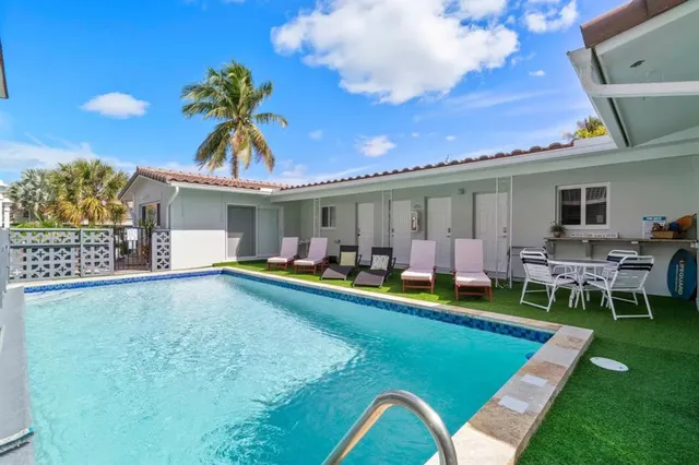 a view of a house with swimming pool having outdoor seating