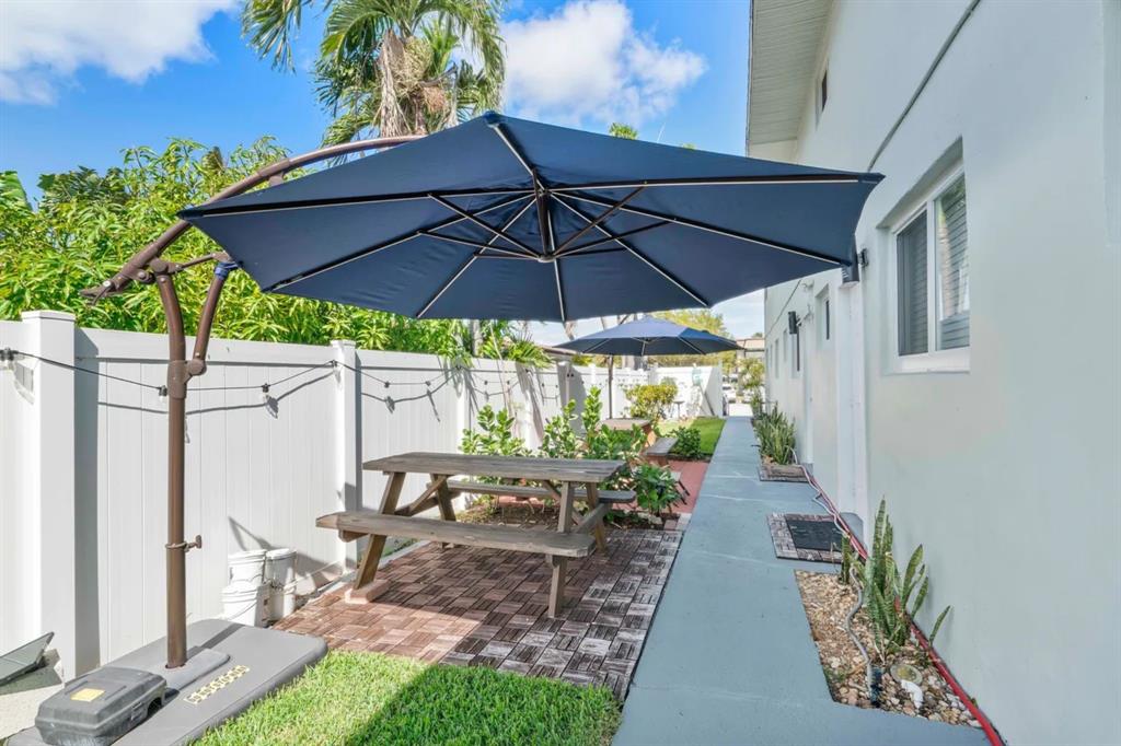 2250 Southeast 5th Street, Unit 6 Pompano Beach, FL 33062 - Photo 10 of 11 a view of a patio with chairs under an umbrella