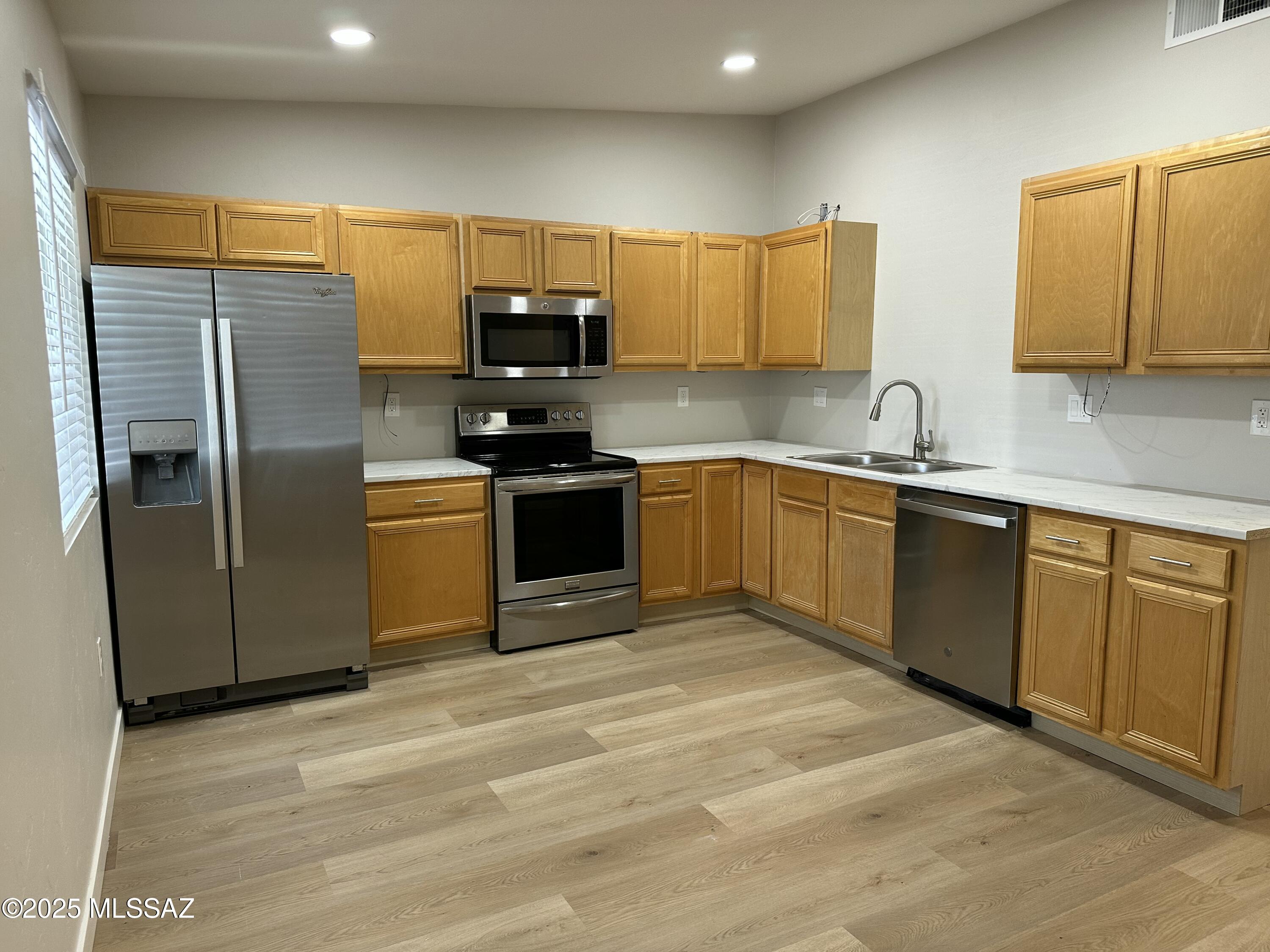 645 East Mabel Street Tucson, AZ 85705 - Photo 4 of 22 a kitchen with stainless steel appliances granite countertop a stove a sink dishwasher a refrigerator and a microwave oven