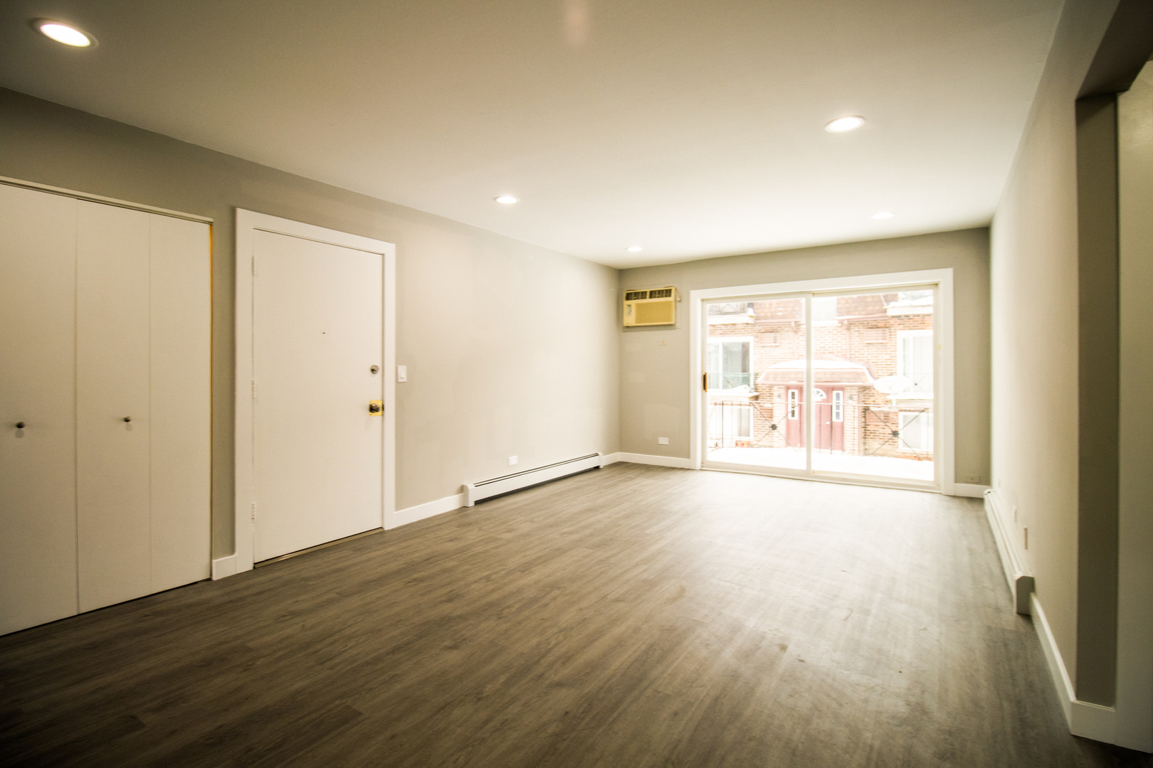 10457 Dearlove Road, Unit 1A Glenview, IL 60025 - Photo 4 of 12 a view of an empty room with wooden floor and a window