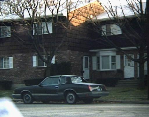 a car parked in front of a brick house
