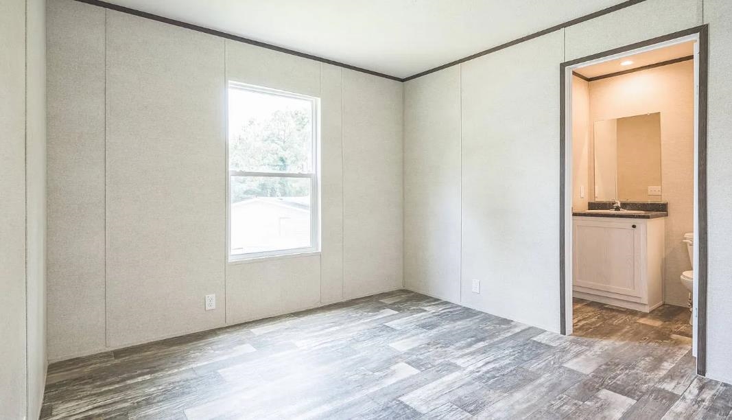 600 Ermine Road West Columbia, SC 29170 - Photo 11 of 20 Unfurnished bedroom featuring wood finished floors, crown molding, and ensuite bathroom