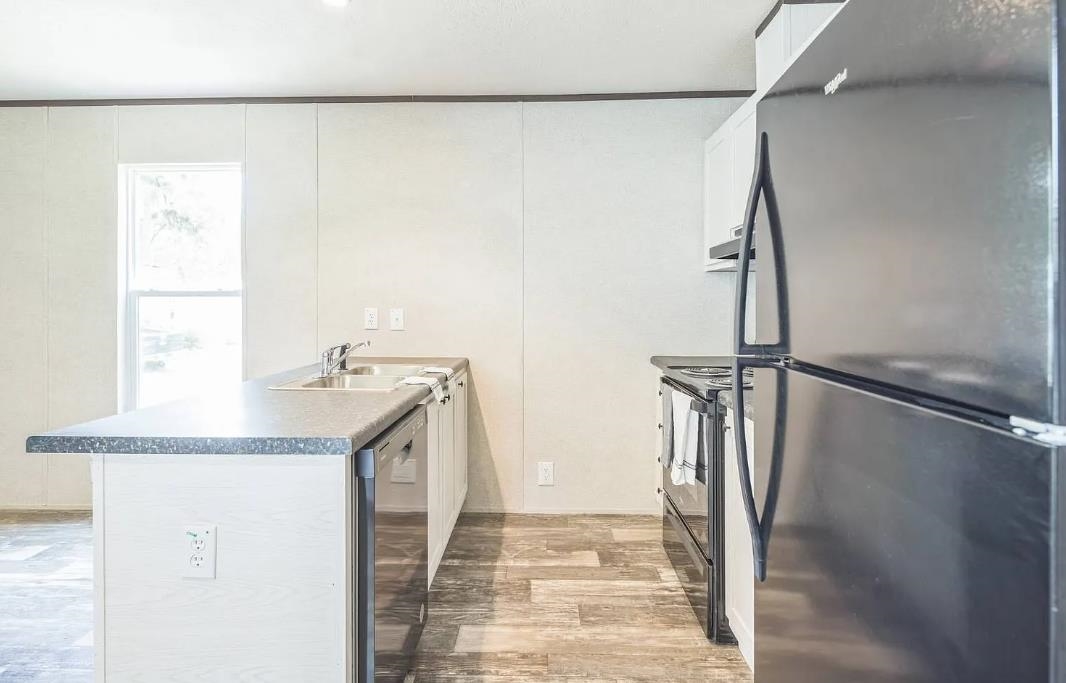 600 Ermine Road West Columbia, SC 29170 - Photo 5 of 20 Kitchen with stainless steel appliances, a peninsula, a decorative wall, light wood-style flooring, and dark countertops