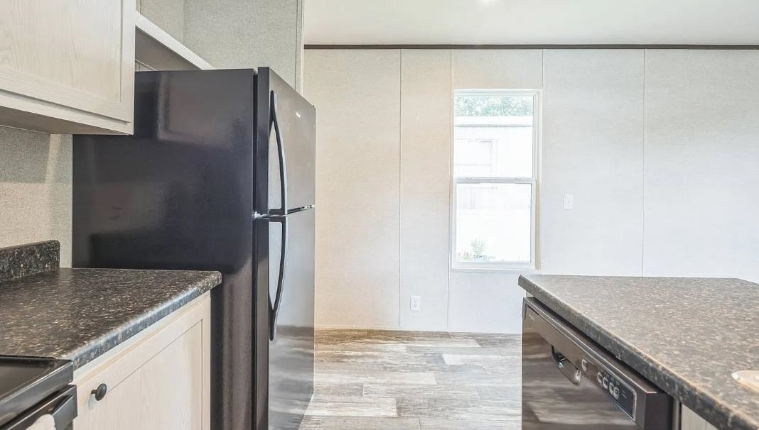 600 Ermine Road West Columbia, SC 29170 - Photo 9 of 20 Kitchen featuring black appliances, light wood finished floors, and a decorative wall
