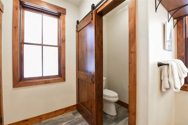 a bathroom with a toilet and a shower