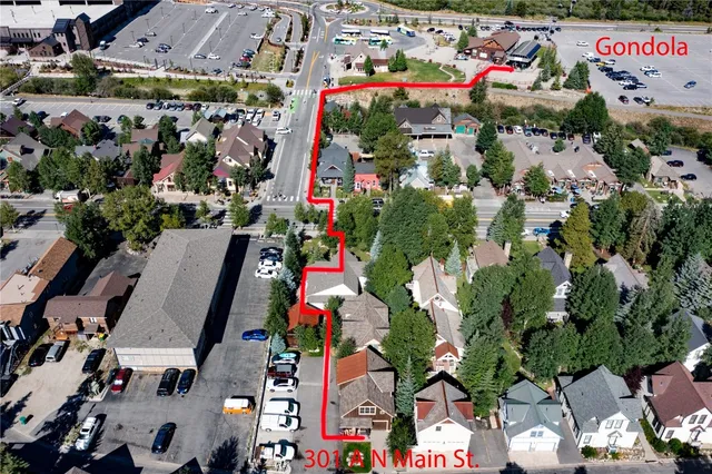 a view of a house with a yard and potted plants