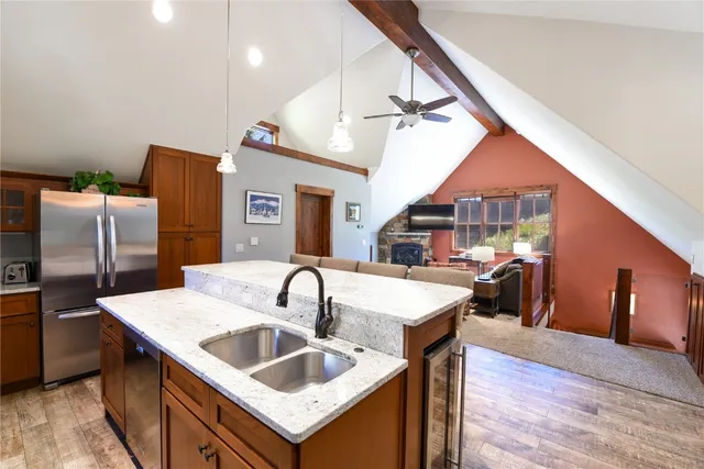 a kitchen with a sink a counter space appliances and cabinets